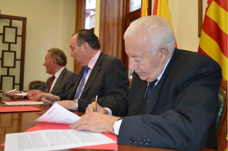 Enrique Rico, en primer pla, signa el conveni / R. Lledó